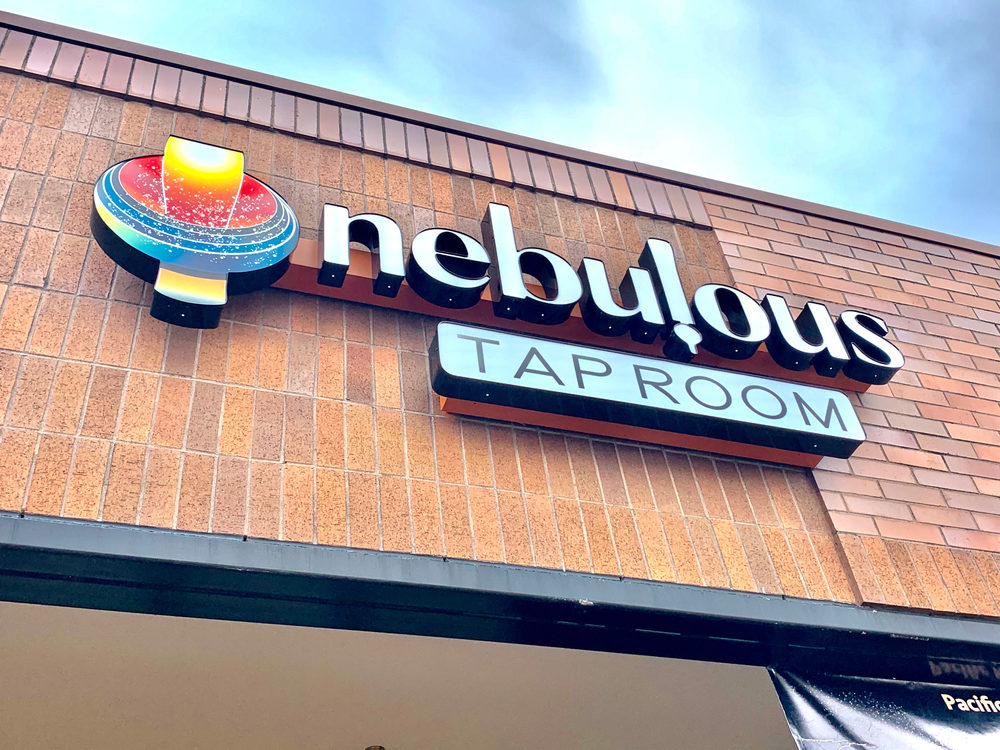Nebulous Taproom sign on a brick storefront